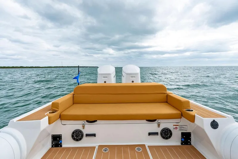 Slide: The Image of Rafnar Targa 40 boat, 2022 model, with tan seating, on open water under cloudy sky. - 16