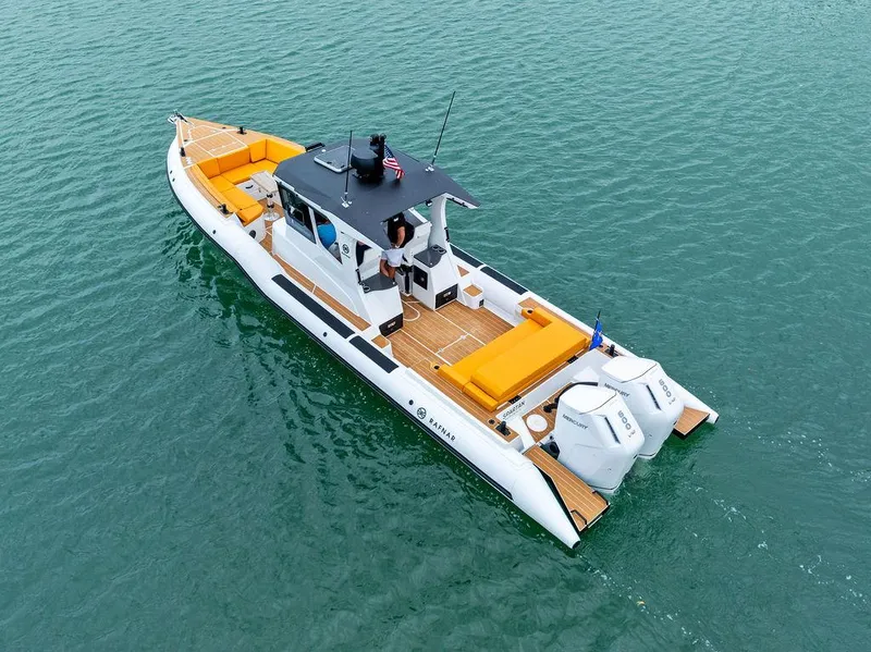 Slide: The Image of Rafnar Targa 40 boat, 2022 model, cruising on calm waters with vibrant orange seating. - 2