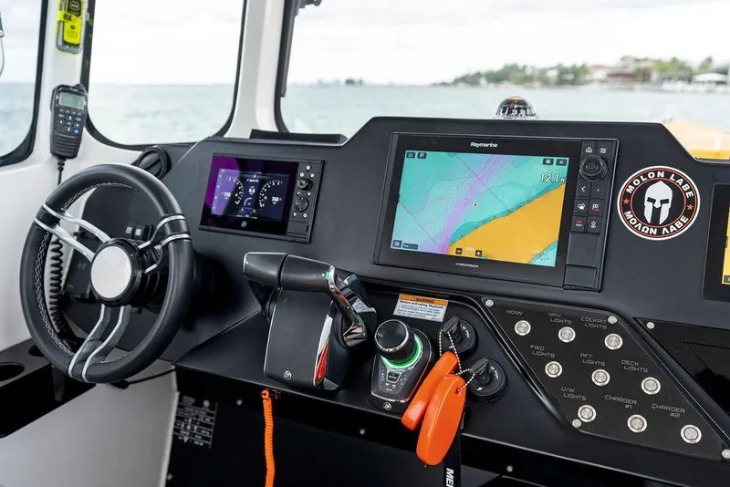 Slide: The Image of Control panel of 2022 Rafnar Targa 40 boat with navigation screens and steering wheel. - 24