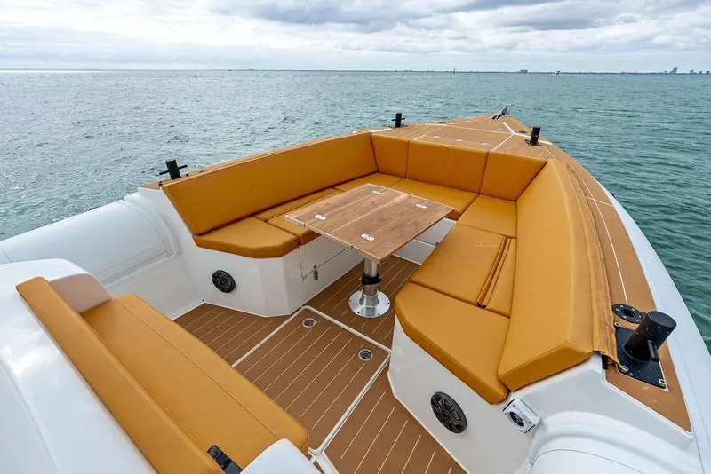 Slide: The Image of Rafnar Targa 40 boat, 2022 model, featuring spacious seating and wooden table on open water. - 27