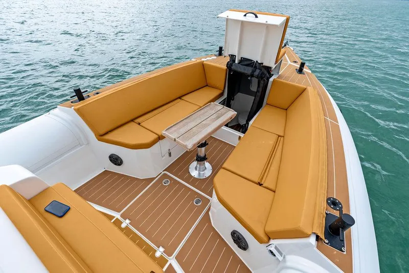 Slide: The Image of Rafnar Targa 40 boat interior, 2022 model, featuring tan seating and a wooden table. - 28