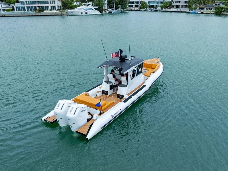 Slide: The Image of Rafnar Targa 40 boat, 2022 model, cruising on calm waters near waterfront homes. - 3