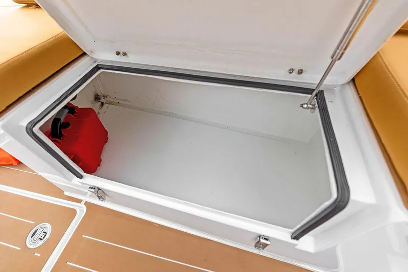 Slide: The Image of Open storage compartment on 2022 Rafnar Targa 40 boat with red life jacket. - 30