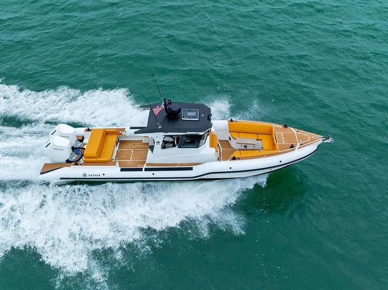 Slide: The Image of 2022 Rafnar Targa 40 boat cruising on open water, featuring sleek design and vibrant seating. - 8