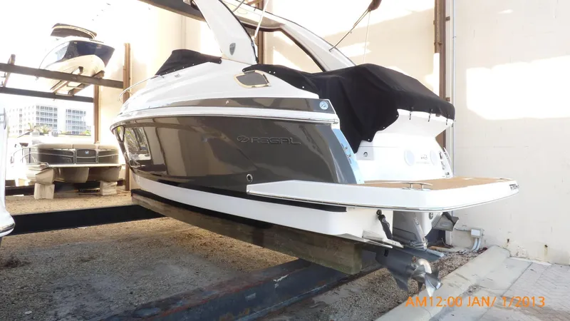 The Image of 2018 Regal 28 Express boat in storage, side view with covered deck. - 1