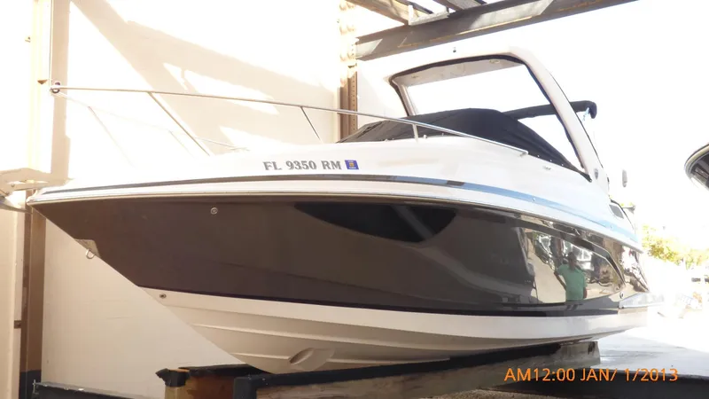 Slide: The Image of 2018 Regal 28 Express boat in storage, side view. - 13
