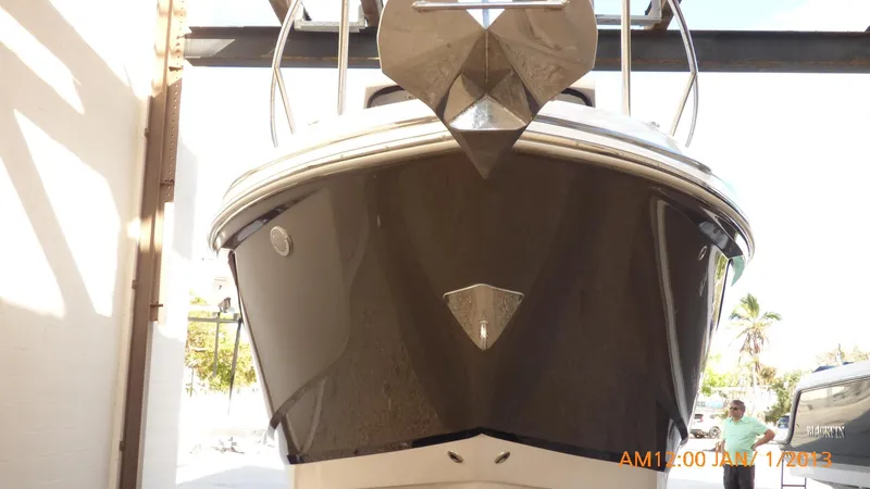 Slide: The Image of 2018 Regal 28 Express boat, front view in a sunlit garage. - 15