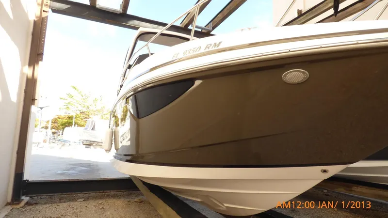 Slide: The Image of 2018 Regal 28 Express boat in storage, side view. - 16