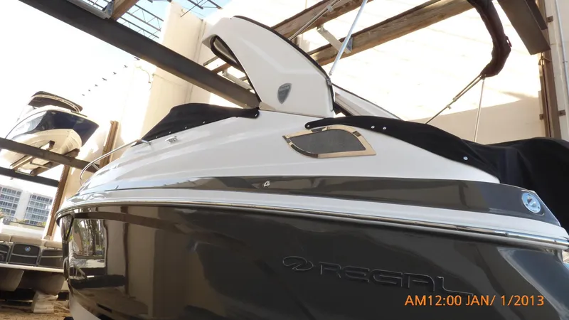 Slide: The Image of 2018 Regal 28 Express boat in storage, side view with cover. - 19