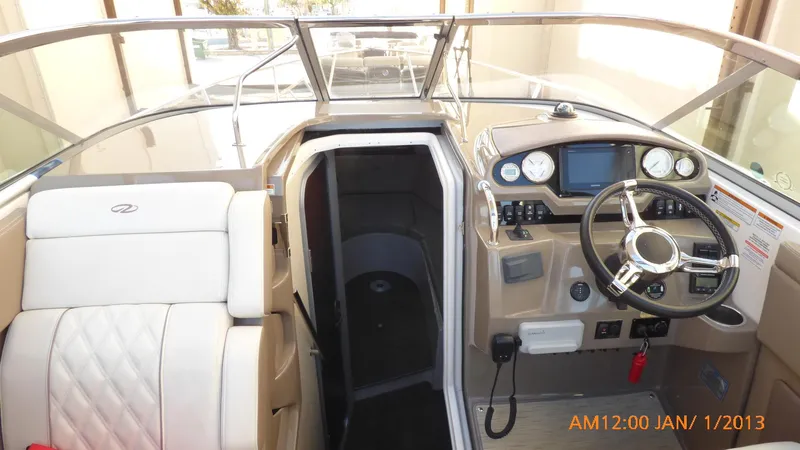 Slide: The Image of 2018 Regal 28 Express boat interior with steering wheel and cabin entrance. - 23