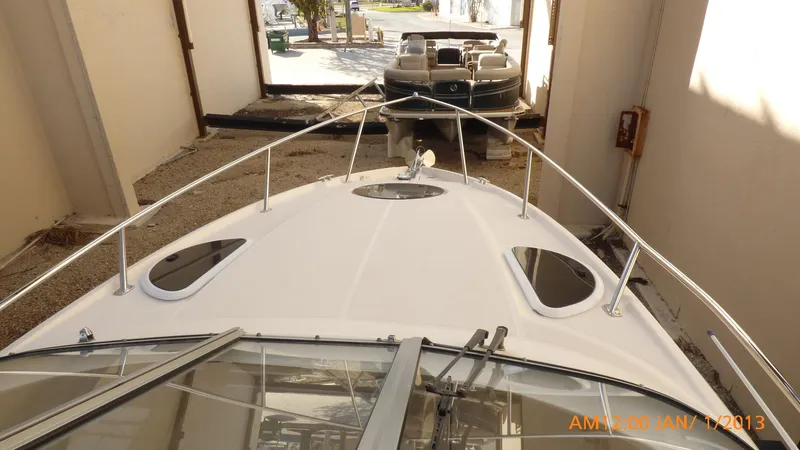 Slide: The Image of 2018 Regal 28 Express boat in storage, viewed from the bow. - 24