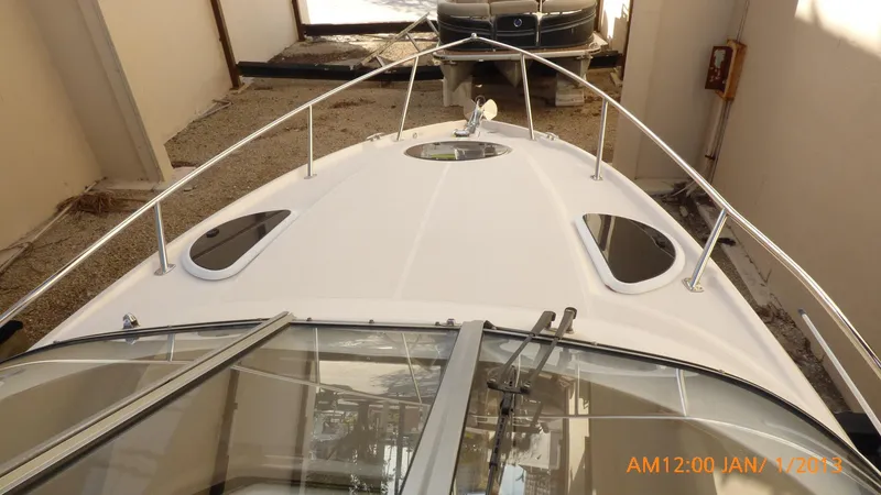 Slide: The Image of 2018 Regal 28 Express boat, top view, docked indoors. - 26
