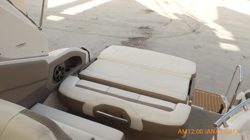 Slide: The Image of 2018 Regal 28 Express boat interior with beige seating and speaker. - 27