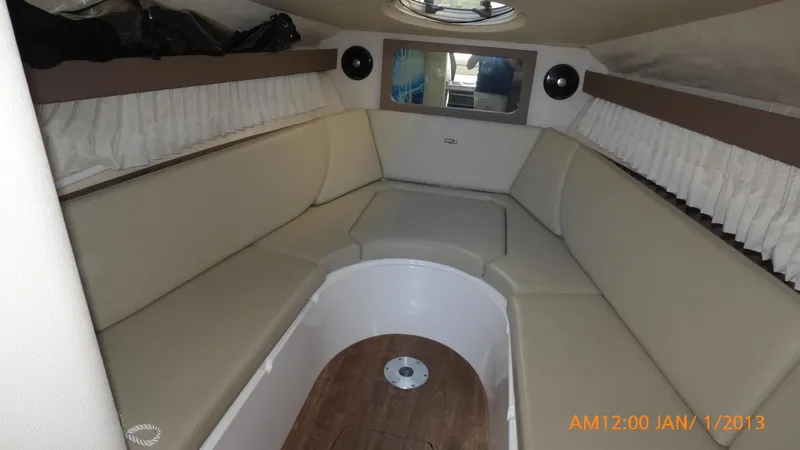 Slide: The Image of Interior of 2018 Regal 28 Express boat with beige seating and wood flooring. - 28