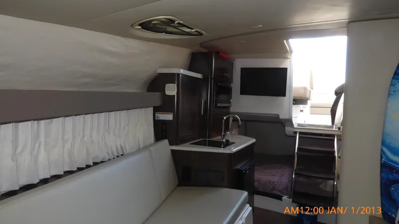 Slide: The Image of Interior of 2018 Regal 28 Express boat with kitchenette and seating area. - 29