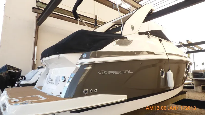 Slide: The Image of 2018 Regal 28 Express boat with sleek design in storage facility. - 3