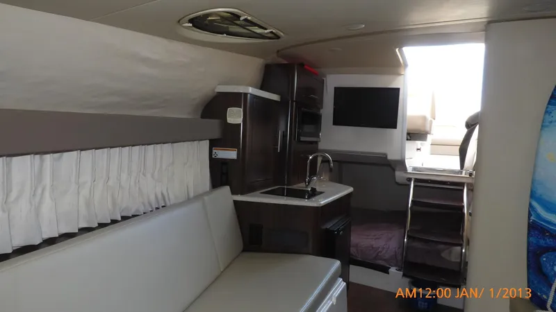 Slide: The Image of Interior of 2018 Regal 28 Express boat with kitchenette and seating area. - 30