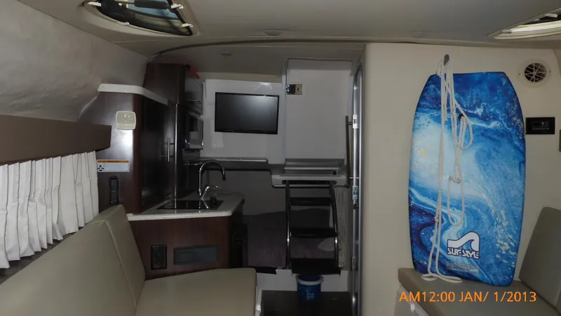 Slide: The Image of Interior of 2018 Regal 28 Express boat with kitchenette and surfboard. - 31