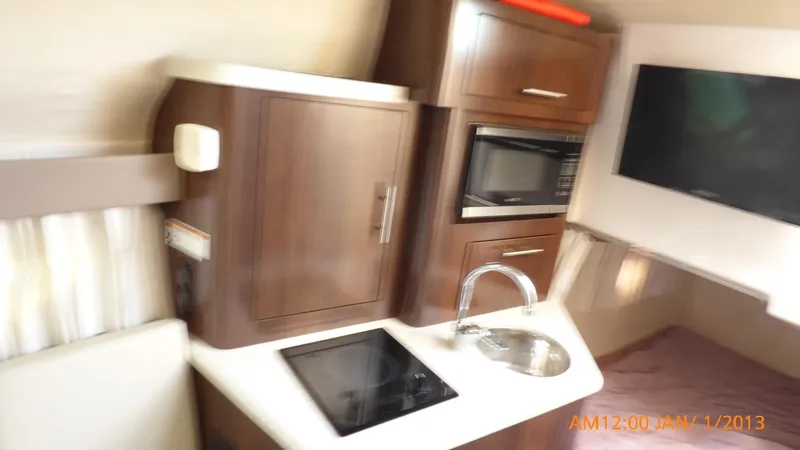 Slide: The Image of Interior of 2018 Regal 28 Express boat with kitchenette and TV. - 33
