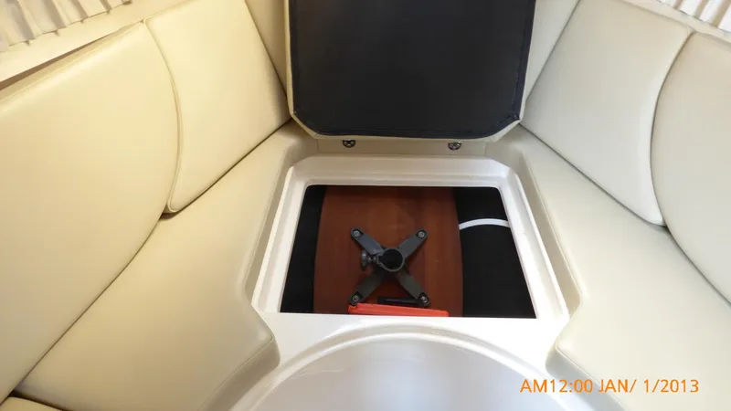 Slide: The Image of Interior of 2018 Regal 28 Express boat with storage compartment open. - 36