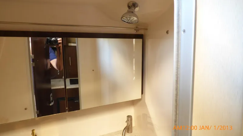Slide: The Image of Bathroom interior of 2018 Regal 28 Express boat with mirror and faucet. - 39