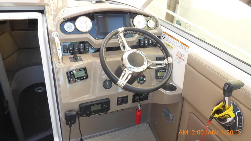 Slide: The Image of 2018 Regal 28 Express boat dashboard with steering wheel and control panel. - 44