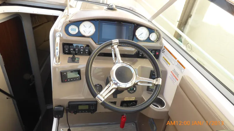 Slide: The Image of 2018 Regal 28 Express boat dashboard with steering wheel and control panel. - 45