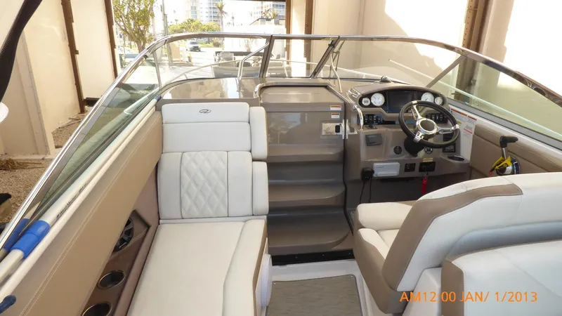 Slide: The Image of Interior of 2018 Regal 28 Express boat with beige seating and modern dashboard. - 46