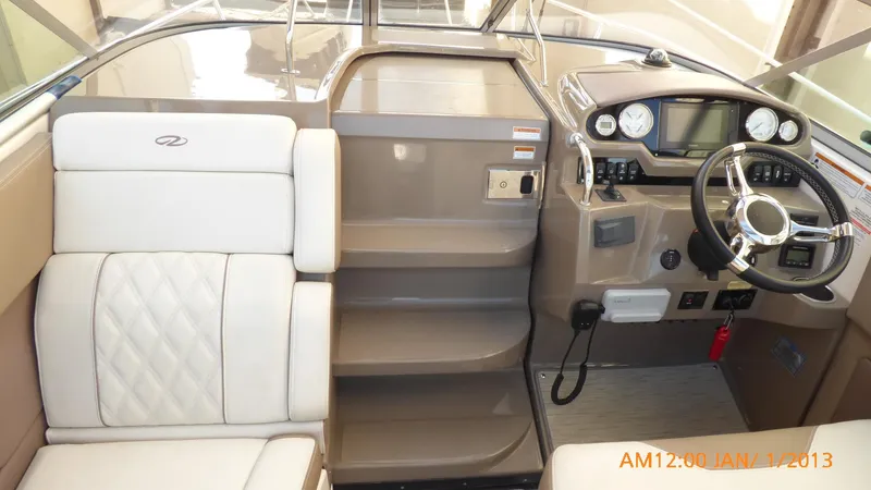 Slide: The Image of Interior of 2018 Regal 28 Express boat with steering wheel and seating. - 47