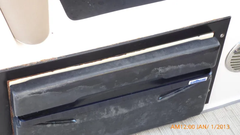 Slide: The Image of Close-up of a 2018 Regal 28 Express boat compartment with a black cover. - 49
