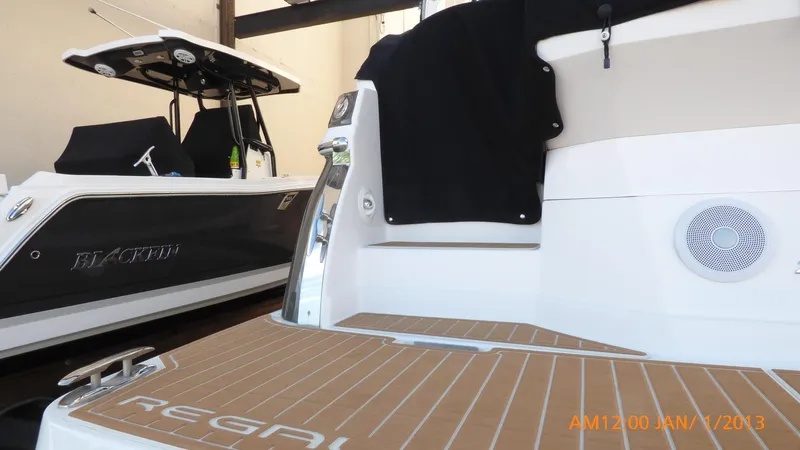 Slide: The Image of 2018 Regal 28 Express boat in showroom, featuring sleek design and modern amenities. - 5