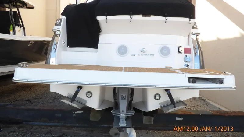 Slide: The Image of 2018 Regal 28 Express boat rear view with swim platform and outboard motor. - 6