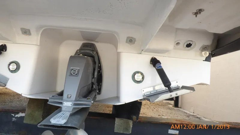 Slide: The Image of 2018 Regal 28 Express boat stern with outdrive and trim tabs. - 9