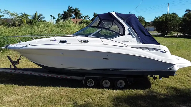 Slide: The Image of 2006 Sea Ray 320 Sundancer boat on trailer, parked on grass. - 1