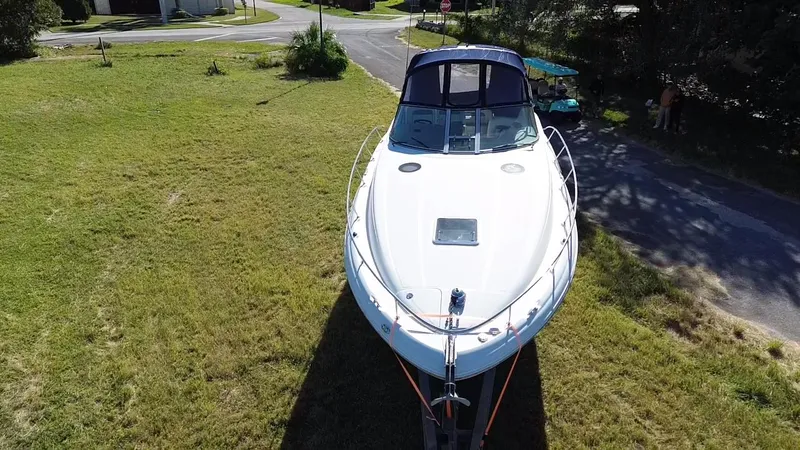 Slide: The Image of Aerial view of 2006 Sea Ray 320 Sundancer boat on grassy area. - 11