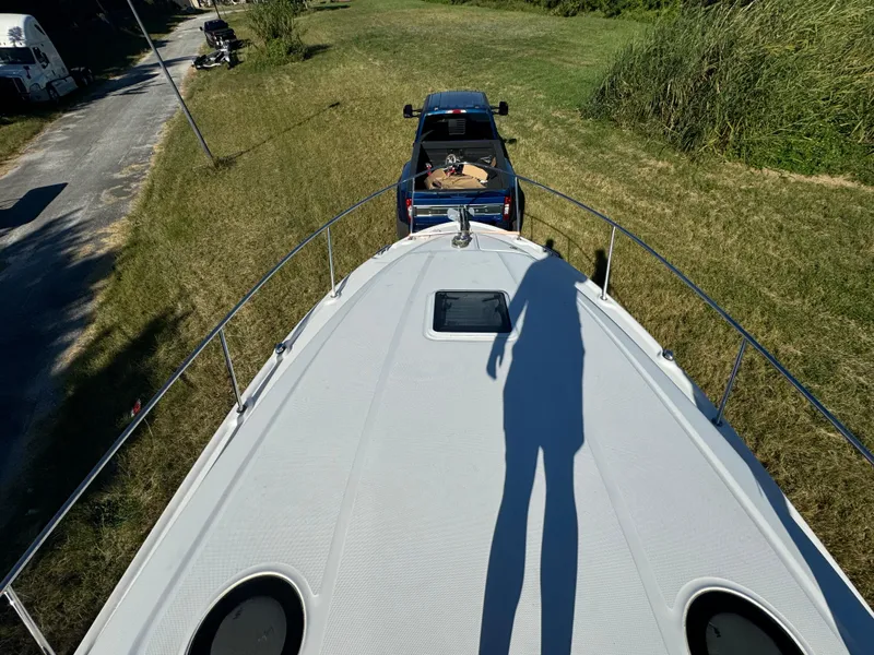 Slide: The Image of View from 2006 Sea Ray 320 Sundancer boat, shadow cast on deck, truck in background. - 14