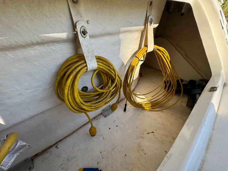 Slide: The Image of Coiled yellow ropes in storage compartment of 2006 Sea Ray 320 Sundancer boat. - 28