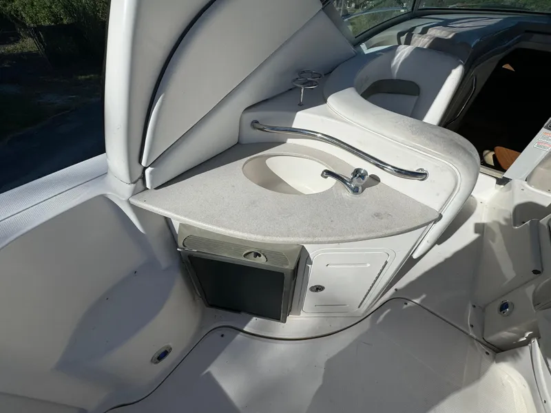 Slide: The Image of 2006 Sea Ray 320 Sundancer boat interior with sink and storage area. - 43