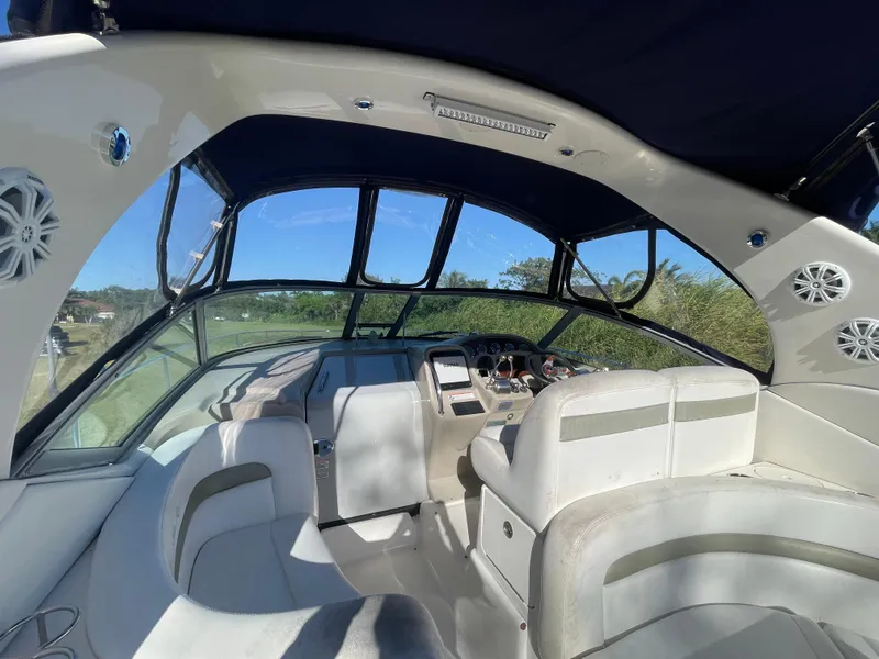 Slide: The Image of Interior of 2006 Sea Ray 320 Sundancer boat with white seating and panoramic windows. - 47