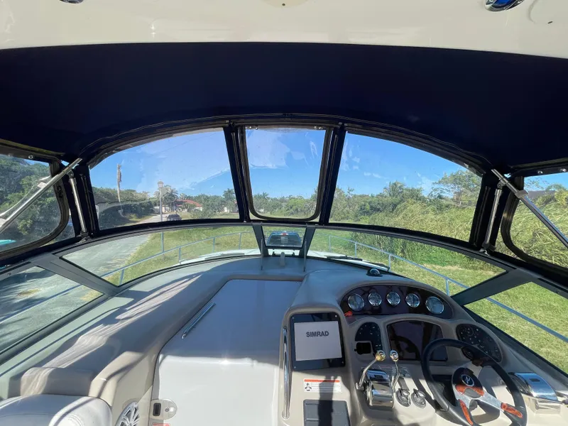 Slide: The Image of Interior view of 2006 Sea Ray 320 Sundancer boat cockpit with steering wheel and dashboard. - 48