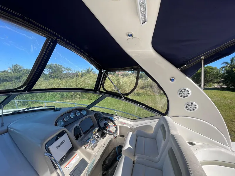 Slide: The Image of Interior view of 2006 Sea Ray 320 Sundancer boat cockpit with steering wheel and seating. - 54