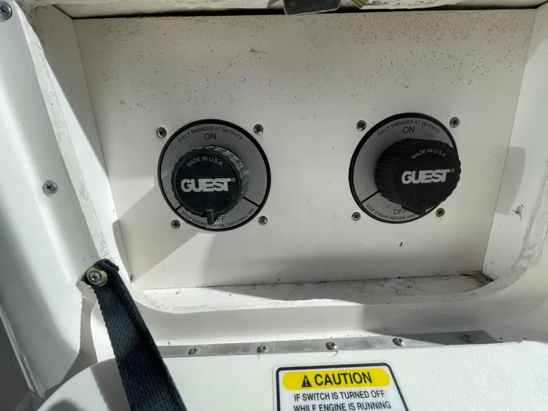 Slide: The Image of Boat battery switches on a 2006 Sea Ray 320 Sundancer with caution label. - 58
