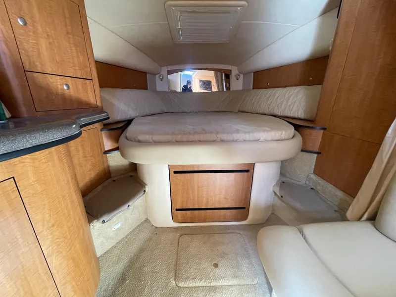 Slide: The Image of Interior cabin of 2006 Sea Ray 320 Sundancer with cozy bed and wooden cabinetry. - 65