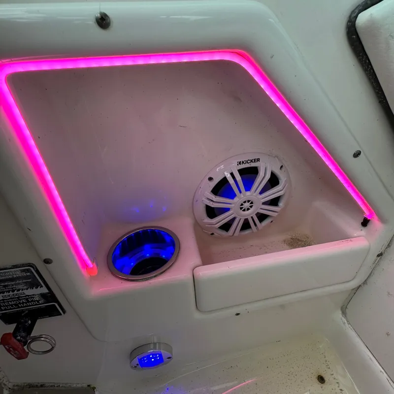 Slide: The Image of 2006 Sea Ray 320 Sundancer interior with pink LED lights and Kicker speaker. - 88