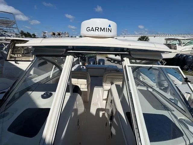 Slide: The Image of 2018 Grady-White Freedom 325 boat with Garmin equipment, docked under a clear blue sky. - 17