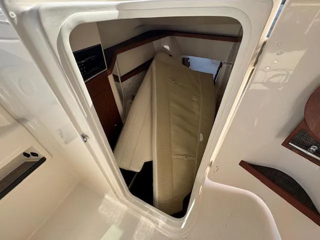 Slide: The Image of 2018 Grady-White Freedom 325 cabin interior with beige seating and wood accents. - 20