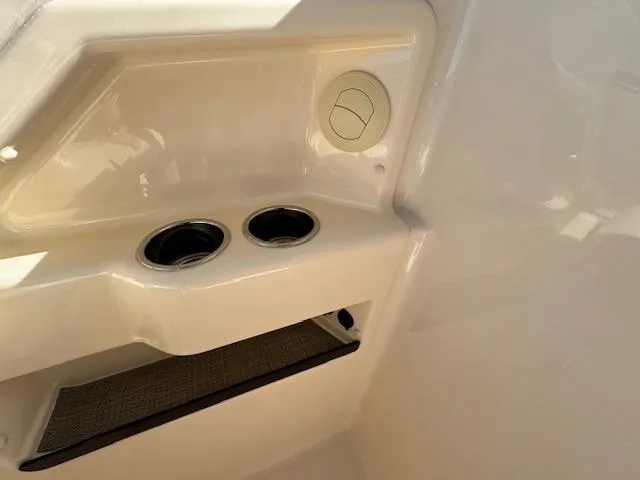 Slide: The Image of 2018 Grady-White Freedom 325 boat interior with cup holders and storage compartment. - 22