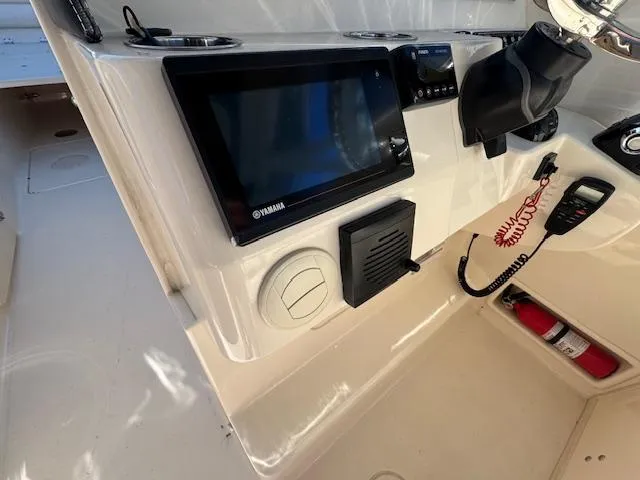 Slide: The Image of 2018 Grady-White Freedom 325 boat dashboard with Yamaha display and safety equipment. - 23