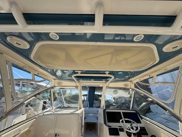 Slide: The Image of 2018 Grady-White Freedom 325 boat interior with modern helm and spacious seating. - 25