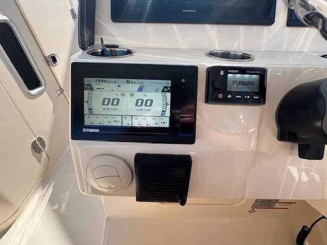 Slide: The Image of Control panel of 2018 Grady-White Freedom 325 boat with Yamaha display and Fusion audio system. - 29